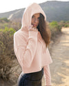 Model wearing blush color hooded sweatshirt