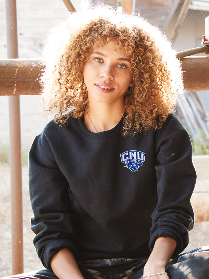 Christopher Newport University Crewneck Sweatshirt embroidered with choice of CNU Captains logos on the left chest. Classic unisex fit CNU Captains sweatshirt in royal, white, heather grey or black.  Unisex sizing S-4XL