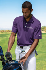 Lifestyle photo of male golfing, wearing the purple Kansas State University polo.  
