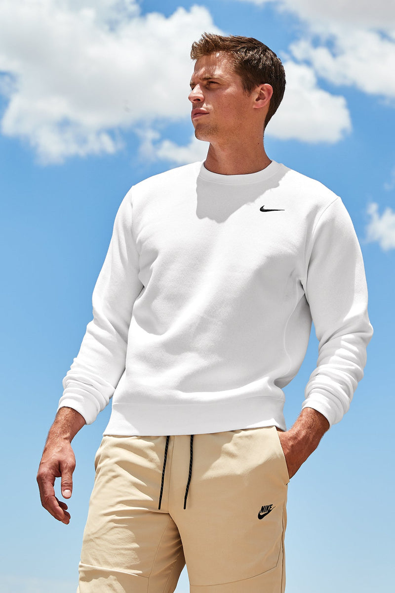 Male model wearing white Nike crewneck
