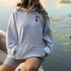 female model wearing the athletic grey sweatshirt with the Furman paladin